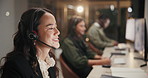 Woman, call center and consulting with headphones at night for customer service or support at office. Female person, employee or agent talking for communication, CRM or telemarketing at workplace