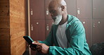 Communication, smartphone and black man in locker room reading message for online news or blog. Mature male person, mobile tech and text in dressing area for digital notification and internet