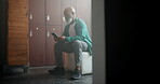 Communication, smartphone and black man in locker room reading message for online news or blog. Mature male person, mobile tech and text in dressing area for retirement notification and internet info