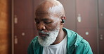 Music, earphones and black man in gym for fitness, streaming podcast or audio. Radio, mature and sports person on technology for listening to sound to relax before workout or exercise at health club