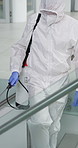 Person, hazmat suit and spray chemical for cleaning on stairs, pandemic and disinfection for virus protection. Worker, bottle and lockdown for illness spread in office, safe and biohazard with policy