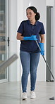 Happy, woman or housekeeper mopping, dancing and singing while cleaning floors for hygiene at home. Smile, woman and gloves with music for housework, chores and karaoke performance in kitchen