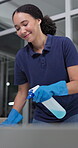 Woman, spray and wipe in office happy for surface cleaning, maintenance services or bacteria removal. Female person, smile and bottle with liquid product for dirt, health care and safety in workplace