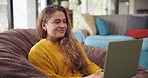 Relax, sofa and happy woman in home with laptop, typing and reading on website for freelance career. Research, networking and girl in living room with remote work, writing and computer for online job