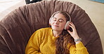 Headphones, music and relax with woman on pouf in living room of home for weekend streaming. Eyes closed, face and radio with happy person listening to audio or sound in apartment from above