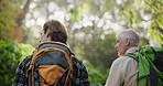 Nature, travel and men with backpack in rainforest for environment, adventure and hiking in Thailand. Dad, son and walking by trees in woods for trekking, journey or exploring together on fathers day