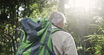 Walking, back and elderly man in forest with trees for holiday adventure and trekking challenge. Travel journey, retirement and senior guy in nature park for camping vacation with trail in Brazil