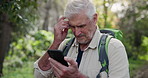 Lost, forest and elderly man with phone for online gps, camping holiday and direction for hiking adventure. Mobile, nature park and senior guy with search for trail location and digital map in Brazil