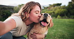 Happy woman, kiss dog and selfie outdoor for care, love and friends bonding together in nature. Animal, girl and portrait of pet owner with golden retriever at park for relax, hug and photography