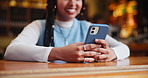 Happy woman, hands and typing with phone at cafe for communication or social media at indoor restaurant. Closeup of female person with smile on mobile smartphone for online browsing at coffee shop