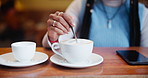 Coffee, hands and stir drink in cafe for morning breakfast, latte and espresso in restaurant. Mixing, spoon and person in cafeteria for beverage preparation with cream, milk or sugar in cup in shop