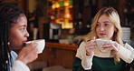 Women, coffee and conversation in cafe as friends with chat, funny and gossip news for social connect. Girls, latte and communication in New York restaurant in morning for advice, relax and talking