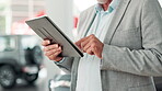 Hands, car dealership and tablet for sales, auto and showroom for professional. Technology, consultant and or businessman, seller and male person for customer service agent for online buyer contract