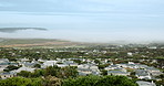 Neighborhood, panorama and sky with residential buildings outdoor in nature for community housing. Home, property or real estate with view of architecture, development or green landscape in morning