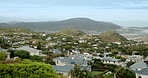 Neighborhood, sky and view with residential buildings outdoor in nature for community housing. Home, property or real estate with panorama of architecture, development or green landscape in morning