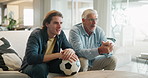 Senior father, son and watching tv on sofa for support, sports and happy bonding together in home. Television, dad and excited adult child on couch with football, soccer ball and relax on weekend