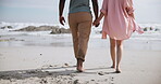 Beach, walking and couple holding hands on romantic date for love, support and travel or holiday together. Man, woman and vacation on seashore barefoot for adventure, explore and summer sunset