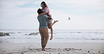 Couple, hug and dance at beach with outdoor romance, holiday and vacation by ocean. Excited interracial people spinning together with love, fun and celebration of anniversary or valentines day by sea