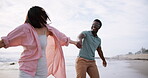 Beach, fun and interracial couple for romance, honeymoon and travel for play, happy and walking. Woman, holding hands or sea on date to show partner adventure, happiness or bonding or joy on holiday