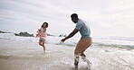 Water splash, couple and playing by beach with love, fun and playful together with happiness on vacation in Australia. Man, woman and ocean waves on holiday for weekend trip, anniversary and game.