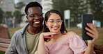 Couple, park bench and selfie in garden with love for memory, content creation and personal blog for social media with care. Man, woman and smile with photography for internet post or live streaming.