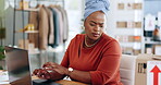 Black woman, laptop and typing in logistics for schedule delivery, order or ecommerce in fashion business. African female working on computer in digital marketing looking at shipping information