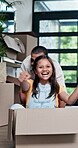 Happy father, girl and playing with box in new home for fun moving in, bonding or property together. Dad pushing child, kid or daughter in boxes to explore apartment, building or living room at house