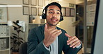 Businessman, consultant and night with headphones at call center for customer service, support or telemarketing. Young man, agent or employee talking with headset for online advice or help at office