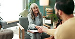 Couple, counseling and therapist with handshake, talk and help in office for marriage. Therapy, greeting and discussion of woman psychologist with support, care and consultation at clinic with notes