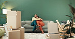 Couple, new home and smile on hug in sofa with boxes for  furniture, renovation and moving in. New house, relationship and happy people with property or ownership for helping, support  and investment