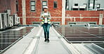 Construction, solar panel and tablet with mature woman on roof in city for inspection or quality control. Engineer, renewable energy and safety with person walking on building for site sustainability