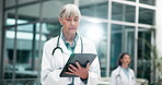 Doctor, tablet and scroll in hospital for research, communication or healthcare development news. Woman, tech and typing in clinic for electronic medical record, telehealth and mobile health app