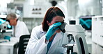 Examine, microscope and science with woman in laboratory for medical discovery or experiment. Breakthrough, innovation and research with scientist at work on cure or vaccine for biology research