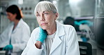 Mature woman, scientist and thinking in lab on computer, medical research and planning investigation. Female person, tired and employee for biotechnology, review and deadline for experiment results