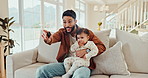 Dad, watching tv and baby in a home with cartoon, movie or children film on a living room couch. Family, streaming and series with remote, television and youth education channel on a lounge sofa