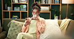 Happy woman, relax and coffee with phone on sofa for morning, communication or reading news at home. Female person drinking beverage, cappuccino or latte on mobile smartphone in living room at house