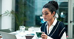 Woman, drinking coffee and working on laptop, creative editor with research and planning in office. Female copywriter, computer and reading for project in corporate company, review or administration