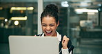 Laptop, project management and winner with business woman in office at night for research.Computer, celebration and success with happy professional employee in creative workplace for online design