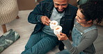 Cheers, new home and happy couple with coffee on living room floor to celebrate goal together. Cappuccino drink, real estate and people in dream house with property investment, mortgage for future