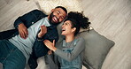 Laughing, couple and pillows on floor of new home with love, bonding and joy for financial growth. Smile, man and woman above for future property investment, support together and dream house mortgage