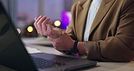 Business person, hands and night with wrist injury on laptop for arthritis, joint ache or inflammation at office. Closeup of employee with sore muscle, pain or carpal tunnel syndrome at workplace