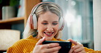 Happy woman, laughing and phone with headphones for watching movie, online streaming or subscription in living room at home. Female person with headset or mobile smartphone on sofa for entertainment