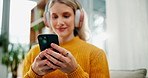 Woman, hands and typing with phone or headphones for online browsing, streaming or subscription at home. Closeup of female person with headset on mobile smartphone for music list or app at house