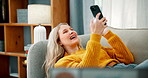 Home, video call and woman with cellphone, wave and contact with social media, network and communication in lounge. Apartment, happy person or girl on couch, greeting and smartphone with conversation