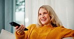 Happy woman, relax and watching tv with entertainment on sofa for movie or show in living room at home. Young female person with smile or remote for online subscription, streaming or series at house