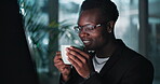 Black man, coffee and drink in office at night for work, overtime and project deadline with computer. Businessman, technology and latte in workplace as software engineer for programming or coding