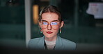 Face, woman and computer in office at night for overtime, deadline and online research as programmer or coder. Female person, employee and serious with glasses for software update and digital data