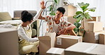 Real estate, high five and couple celebrating on floor in new home, house or living room. Smile, property furniture and man with woman moving in apartment with boxes, joy and excited unpacking