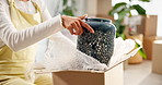 Woman, hands and boxes with ornament in home or new house for moving in with furniture. Female person, ownership and sentimental gift or present and package with unboxing or unpacking and delivery