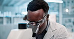 Scientist, black man and microscope or analysis in laboratory for results on medical research and experiment. Innovation, professional and expert with goggles for science development and study review